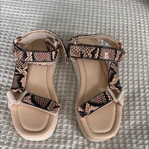 Woman’s snake skin sandals by Vince.